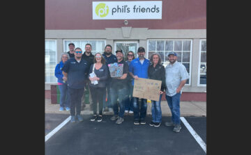 Royal Pools G2 Landscaping team standing in front of Phil's Friends building.